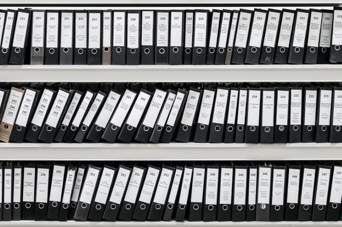 Binders on a shelf.