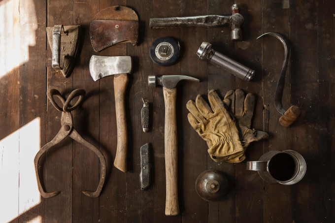 A displayed content of a toolkit displayed showing tools like hammer, axe, box cutter, iron and flashligh.